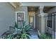 Covered front entrance with a textured wall, leading to a glass-paneled front door at 13207 San Blas Loop, Largo, FL 33774