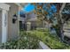 Side view of the townhome with manicured landscaping and clear numbering for easy identification at 13207 San Blas Loop, Largo, FL 33774