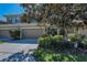 Attractive townhome with a two-car garage and beautifully maintained landscaping in front yard at 13207 San Blas Loop, Largo, FL 33774
