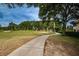 Picturesque golf path winds through the lush green course with mature trees and sand traps at 13207 San Blas Loop, Largo, FL 33774