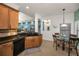 Kitchen features wooden cabinets, dark countertops, and opens to a breakfast nook and living room at 13207 San Blas Loop, Largo, FL 33774