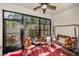 Cozy lanai with comfortable seating, a porch swing, and screened windows offering scenic views at 13207 San Blas Loop, Largo, FL 33774