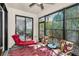 Relaxing sunroom with seating and screened windows offering views of the greenery at 13207 San Blas Loop, Largo, FL 33774