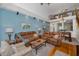 Cozy living room area with comfortable sofas, hardwood floors, and access to the dining area at 13207 San Blas Loop, Largo, FL 33774