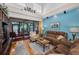 Comfortable living room with plush sofas and a view of the outdoor patio at 13207 San Blas Loop, Largo, FL 33774