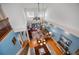 View from above of the living room, showing the high ceilings, comfortable furniture, and outdoor access at 13207 San Blas Loop, Largo, FL 33774