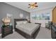 This is a spacious main bedroom with a wooden bed frame, a ceiling fan, and a window that provides plenty of natural light at 13207 San Blas Loop, Largo, FL 33774