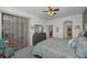 The spacious main bedroom offers patio access, a ceiling fan, and entry to walk-in closet and main bath at 13207 San Blas Loop, Largo, FL 33774