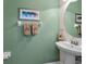 The powder room includes a decorative mirror, palm tree art, and towel set at 13207 San Blas Loop, Largo, FL 33774