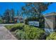 Community entrance sign for Beacon Trace, surrounded by landscaping and a glimpse of the homes beyond at 13207 San Blas Loop, Largo, FL 33774