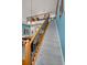 Bright staircase with wood and iron railing leads to a loft overlooking a dining area with a chandelier at 13207 San Blas Loop, Largo, FL 33774