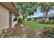 Lush backyard with well-maintained lawn, beautiful landscaping, and connecting pathway at 1426 Ingram Dr # 1426, Sun City Center, FL 33573