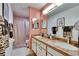 Bathroom featuring double sinks, decorative mirror, and shower with curtain at 1426 Ingram Dr # 1426, Sun City Center, FL 33573