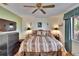 Charming bedroom showcasing wood floors, ceiling fan, and bright natural light at 1426 Ingram Dr # 1426, Sun City Center, FL 33573