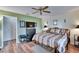 Well-lit bedroom showcasing wood floors, media center, and comfortable furnishings at 1426 Ingram Dr # 1426, Sun City Center, FL 33573