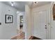 Welcoming entryway featuring wood-look floors, crisp white walls, and a bedroom view, offering a glimpse of the home's interior at 1426 Ingram Dr # 1426, Sun City Center, FL 33573