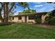 Inviting front exterior showcasing a well-manicured lawn and a peaceful, suburban setting at 1426 Ingram Dr # 1426, Sun City Center, FL 33573