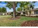 Exterior of home with mature landscaping and trees, adding to its curb appeal at 1426 Ingram Dr # 1426, Sun City Center, FL 33573