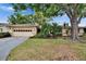 Charming home featuring a two-car garage and is surrounded by lush tropical landscaping at 1426 Ingram Dr # 1426, Sun City Center, FL 33573