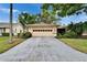 Charming home featuring a two-car garage and a long driveway, surrounded by lush landscaping at 1426 Ingram Dr # 1426, Sun City Center, FL 33573