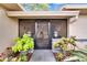 Enclosed front porch featuring decorative ironwork and colorful, lush landscaping at 1426 Ingram Dr # 1426, Sun City Center, FL 33573
