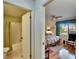 Hallway view to bedroom and bathroom featuring wood floors and natural light at 1426 Ingram Dr # 1426, Sun City Center, FL 33573