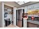 Cozy kitchen featuring a pantry, white cabinets, stainless steel refrigerator, and modern appliances at 1426 Ingram Dr # 1426, Sun City Center, FL 33573