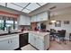 Bright kitchen featuring white cabinets, modern appliances, and an adjacent dining area at 1426 Ingram Dr # 1426, Sun City Center, FL 33573