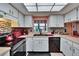 Bright kitchen with white cabinets, stainless steel appliances, a window, and a skylight at 1426 Ingram Dr # 1426, Sun City Center, FL 33573