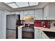 Cozy kitchen featuring white cabinets, stainless steel refrigerator, and modern appliances at 1426 Ingram Dr # 1426, Sun City Center, FL 33573