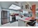 Kitchen featuring a breakfast bar, stainless steel refrigerator, skylight, and modern appliances at 1426 Ingram Dr # 1426, Sun City Center, FL 33573