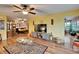 Open-concept living room with a ceiling fan, entertainment center, and ample seating, ideal for gatherings and relaxation at 1426 Ingram Dr # 1426, Sun City Center, FL 33573