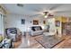 Inviting living room featuring a ceiling fan, stylish seating, and a glass coffee table, designed for comfortable living at 1426 Ingram Dr # 1426, Sun City Center, FL 33573