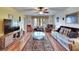 Spacious living room with a ceiling fan, sleek furniture, and a large window, creating a comfortable and inviting space at 1426 Ingram Dr # 1426, Sun City Center, FL 33573