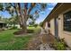 Side yard with walkway and mature landscaping, enhancing the home's curb appeal at 1426 Ingram Dr # 1426, Sun City Center, FL 33573