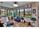 Bright sunroom with large windows offering a view of the manicured lawn and garden at 1426 Ingram Dr # 1426, Sun City Center, FL 33573