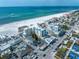 Breathtaking aerial view of beachfront condos, pristine white sand beach, and sparkling turquoise ocean water at 15 Avalon St # 303, Clearwater Beach, FL 33767