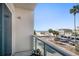 Balcony view overlooking the beach, palm trees, and street, creating a serene coastal living experience at 15 Avalon St # 303, Clearwater Beach, FL 33767