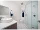 Bright bathroom featuring a walk-in shower, modern toilet, and a sleek, white vanity at 15 Avalon St # 303, Clearwater Beach, FL 33767