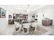 Bright dining room with glass table, modern chairs, and a decorative chandelier at 15 Avalon St # 303, Clearwater Beach, FL 33767