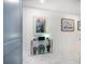 Stylish hallway with a glass console table and tasteful artwork at 15 Avalon St # 303, Clearwater Beach, FL 33767