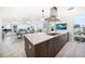 Open kitchen with an island cooktop, modern hood, and views to the dining and living areas at 15 Avalon St # 303, Clearwater Beach, FL 33767