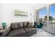 Cozy living room with comfortable seating and a sliding glass door to the balcony at 15 Avalon St # 303, Clearwater Beach, FL 33767