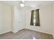 Bright bedroom featuring laminate flooring, a ceiling fan, a window and closet door at 1588 S Prospect Ave, Clearwater, FL 33756