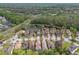 Aerial view showcasing a suburban neighborhood with a pond, lush greenery, and well-maintained streets at 16011 Bella Woods Dr, Tampa, FL 33647