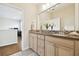 Bathroom with a large mirror, double vanity, and decorative tile backsplash at 16011 Bella Woods Dr, Tampa, FL 33647