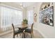 Cozy breakfast nook with a wooden table set, pendant lighting, and sheer curtains at 16011 Bella Woods Dr, Tampa, FL 33647