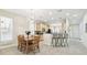 Kitchen and dining area features a breakfast bar, dining table, and stainless steel appliances at 16011 Bella Woods Dr, Tampa, FL 33647