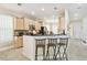 Kitchen with breakfast bar features barstool seating and stainless steel appliances, adjacent to dining area at 16011 Bella Woods Dr, Tampa, FL 33647