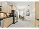 Cozy breakfast nook area featuring tile floors, stainless steel refrigerator, and modern light fixture at 16011 Bella Woods Dr, Tampa, FL 33647